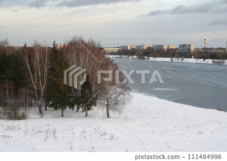 river on a sunny evening. Trees and shrubs. Landscape of winter nature, river banks with bushes. river on a sunny evening. Trees and shrubs. Landscape of winter nature, river banks with bushes. 111484996