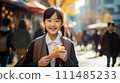 Asian girl eating while walking 111485233