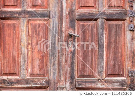 Old, vintage wooden red and pink painted doors detail with steel handle 111485366