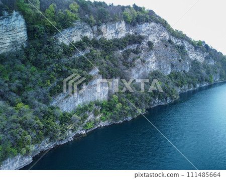 Aerial photography with drone. Steep Cliffs By the Water, Lake Garda, Italy. Aerial photography with drone. Steep Cliffs By the Water, Lake Garda, Italy. 111485664