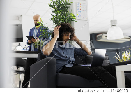 Arab entrepreneur happy about high product sales roi, checking financial report on laptop. Excited start up company executive manager holding head while analyzing investment profit Arab entrepreneur happy about high product sales roi, checking financial report on laptop. Excited start up company executive manager holding head while analyzing investment profit 111486423