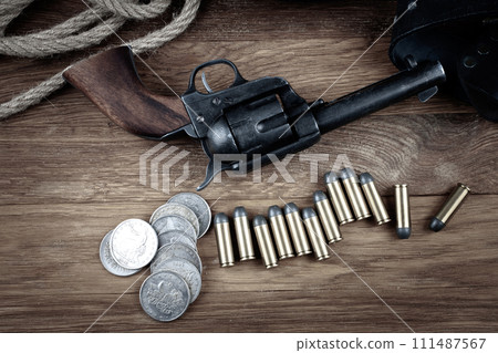 Old west gun with belt, holster and ammunition with silver dollar coins Old west gun with belt, holster and ammunition with silver dollar coins 111487567