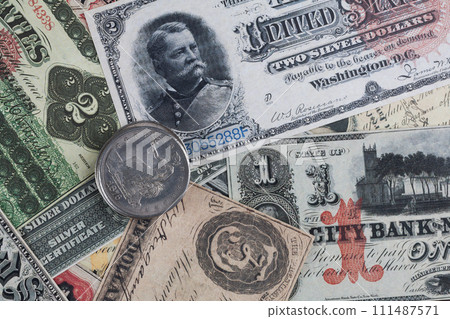 Old west period US banknotes and silver certificates with silver dollar coins 111487571