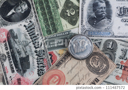 Old west period US banknotes and silver certificates with silver dollar coins 111487572