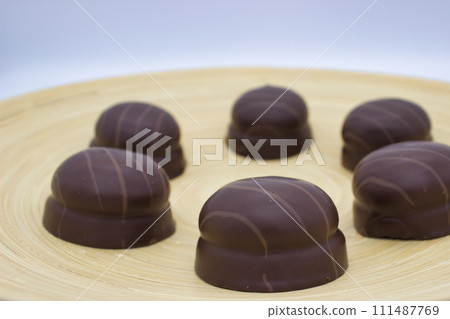 Gourmet Dark Chocolate Pralines on Plate Gourmet Dark Chocolate Pralines on Plate 111487769