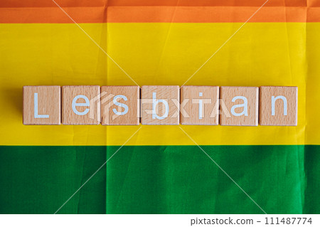 Wooden blocks form the text "Lesbian" against a rainbow background. 111487774