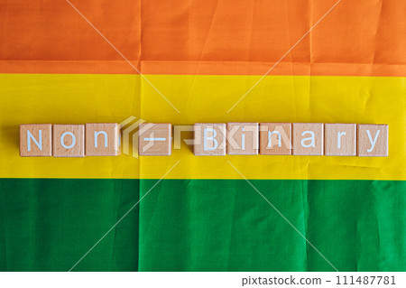 Wooden blocks form the text "Non-Binary" against a rainbow background. Wooden blocks form the text "Non-Binary" against a rainbow background. 111487781