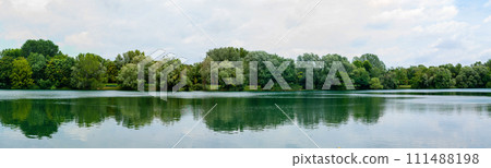 Panoramic view of beautiful lake in park. Landscape with lake, green trees 111488198