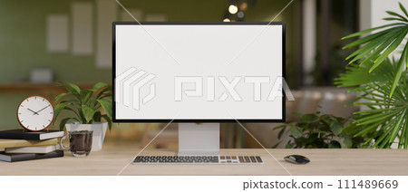 A modern and comfortable home office with a white-screen computer mockup on a hardwood desk. 111489669