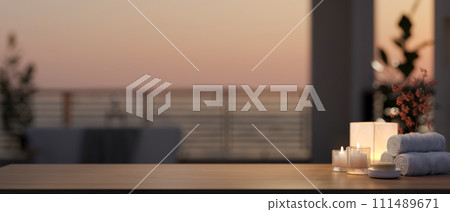 A copy space on a desk with toiletries in a luxury bathroom with a sunset view through a balcony. 111489671