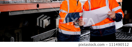 Young caucasian engineer man and woman checking train looking blueprint in station. Young caucasian engineer man and woman checking train looking blueprint in station. 111490512