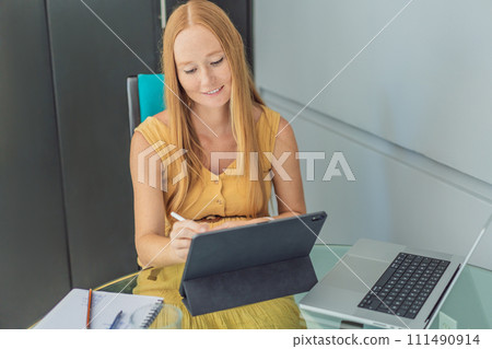 Beautiful pregnant woman working on laptop. Young businesswoman working in her office 111490914