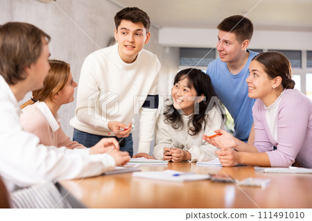 Interested young student taking part in group discussion 111491010