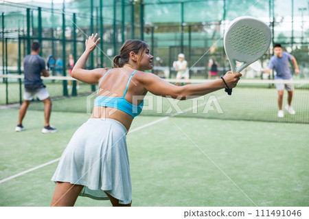 Attractive woman padel tennis player training on court 111491046