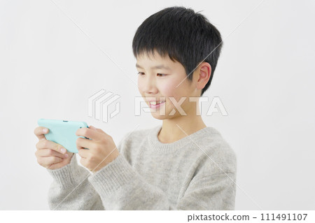 Boy watching video on smartphone, white background 111491107
