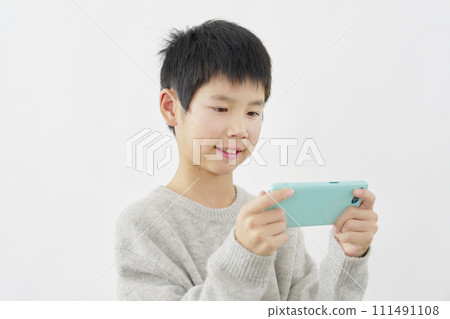 Boy watching video on smartphone, white background 111491108