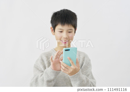 Boy using smartphone, white background 111491116