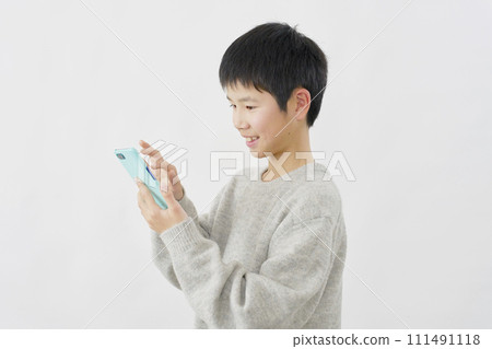 Boy using smartphone, white background 111491118