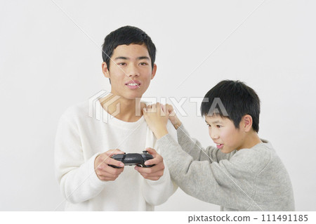 Boy playing video games, white background Boy playing video games, white background 111491185