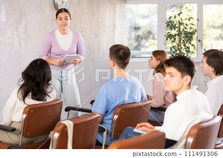 Young female teacher giving lecture to group of students 111491306