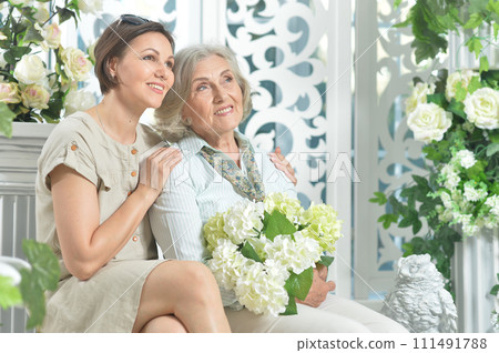 Portrait of senior woman with daughter at home Portrait of senior woman with daughter at home 111491788