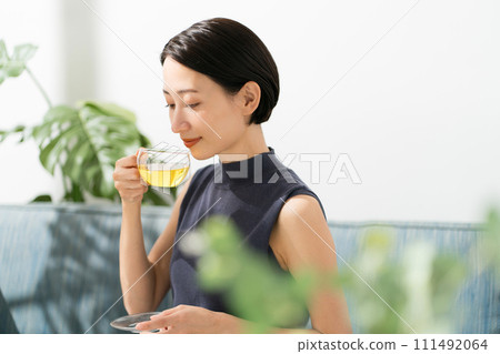 A woman in her 30s drinking herbal tea A woman in her 30s drinking herbal tea 111492064