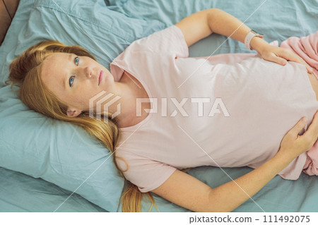 Sleep-deprived pregnant woman struggles with insomnia, navigating the challenges of restlessness during pregnancy Sleep-deprived pregnant woman struggles with insomnia, navigating the challenges of restlessness during pregnancy 111492075