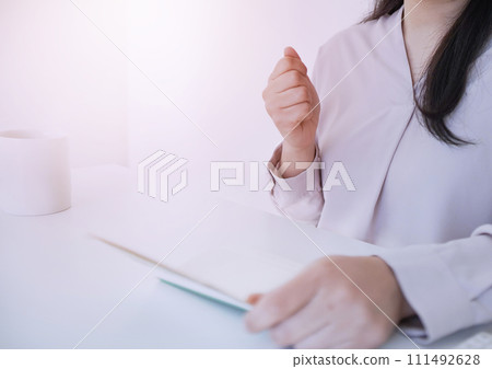 Image of a woman happy to see her bankbook Image of a woman happy to see her bankbook 111492628