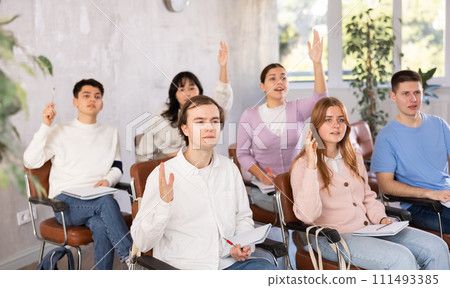Young male student diligently attending lesson in college Young male student diligently attending lesson in college 111493385