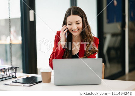 Confident Asian woman with a smile standing holding notepad and tablet 111494248