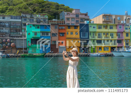 woman traveler visiting in Taiwan, Tourist taking photo by smartphone and sightseeing in Keelung, Colorful Zhengbin Fishing Port, landmark and popular attractions near Taipei city. Asia Travel concept woman traveler visiting in Taiwan, Tourist taking photo by smartphone and sightseeing in Keelung, Colorful Zhengbin Fishing Port, landmark and popular attractions near Taipei city. Asia Travel concept 111495173
