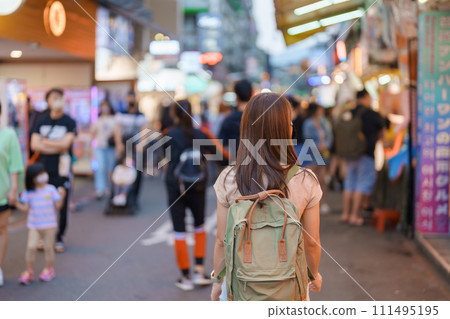 woman traveler visiting in Taiwan, Tourist with bag sightseeing and Shopping in Shilin Night Market, landmark and popular attractions in Taipei city. Asia Travel and Vacation concept 111495195
