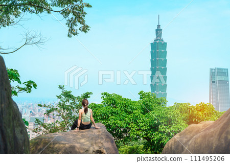 woman traveler visiting in Taiwan, Tourist looking Taipei City during sightseeing and hiking at Elephant Mountain or Xiangshan, landmark and popular attractions. Asia Travel, vacation and Trip concept woman traveler visiting in Taiwan, Tourist looking Taipei City during sightseeing and hiking at Elephant Mountain or Xiangshan, landmark and popular attractions. Asia Travel, vacation and Trip concept 111495206