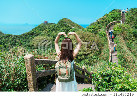 woman traveler visiting in Taiwan, Tourist with backpack sightseeing in Bitou Cape Hiking Trail, New Taipei City. landmark and popular attractions near Taipei. Asia Travel concept woman traveler visiting in Taiwan, Tourist with backpack sightseeing in Bitou Cape Hiking Trail, New Taipei City. landmark and popular attractions near Taipei. Asia Travel concept 111495219