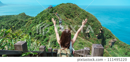 woman traveler visiting in Taiwan, Tourist with backpack sightseeing in Bitou Cape Hiking Trail, New Taipei City. landmark and popular attractions near Taipei. Asia Travel concept woman traveler visiting in Taiwan, Tourist with backpack sightseeing in Bitou Cape Hiking Trail, New Taipei City. landmark and popular attractions near Taipei. Asia Travel concept 111495220