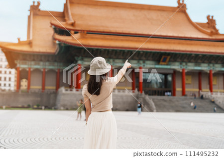 woman traveler visiting in Taiwan, Tourist with hat sightseeing in National Chiang Kai shek Memorial or Hall Freedom Square, Taipei City. landmark and popular attractions. Asia Travel concept 111495232