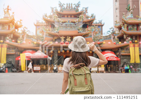 woman traveler visiting in Taiwan, Tourist sightseeing in Songshan Ciyou Temple, near Raohe Night Market, Songshan District, Taipei City. landmark and popular. Travel and Vacation concept 111495251