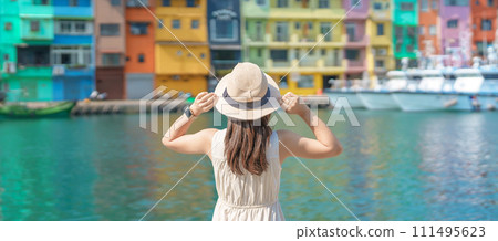 woman traveler visiting in Taiwan, Tourist with hat sightseeing in Keelung, Colorful Zhengbin Fishing Port, landmark and popular attractions near Taipei city . Asia Travel concept 111495623