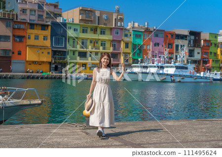 woman traveler visiting in Taiwan, Tourist with hat sightseeing in Keelung, Colorful Zhengbin Fishing Port, landmark and popular attractions near Taipei city . Asia Travel concept woman traveler visiting in Taiwan, Tourist with hat sightseeing in Keelung, Colorful Zhengbin Fishing Port, landmark and popular attractions near Taipei city . Asia Travel concept 111495624