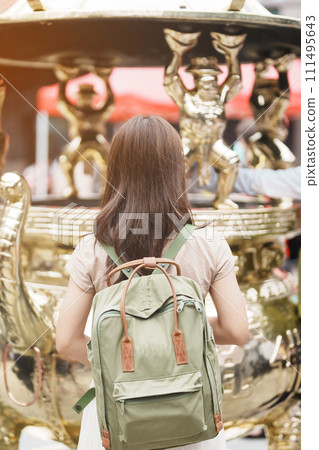 woman traveler visiting in Taiwan, Tourist with hat sightseeing in Longshan Temple, Chinese folk religious temple in Wanhua District, Taipei City. landmark and popular. Travel and Vacation concept 111495643