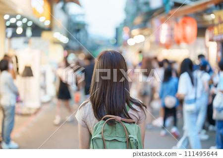 woman traveler visiting in Taiwan, Tourist with bag sightseeing and Shopping in Shilin Night Market, landmark and popular attractions in Taipei city. Asia Travel and Vacation concept 111495644