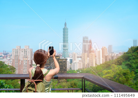 woman traveler visiting in Taiwan, Tourist looking Taipei City during sightseeing and hiking at Elephant Mountain or Xiangshan, landmark and popular attractions. Asia Travel, vacation and Trip concept woman traveler visiting in Taiwan, Tourist looking Taipei City during sightseeing and hiking at Elephant Mountain or Xiangshan, landmark and popular attractions. Asia Travel, vacation and Trip concept 111495649