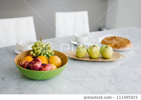 Plate of ripe fruits on a table 111495925