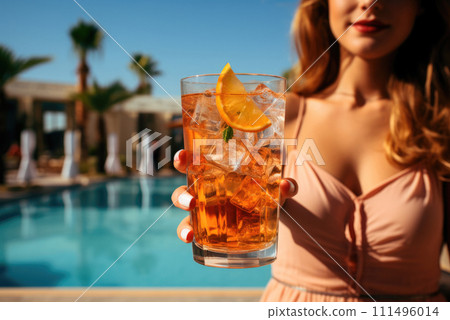 Alcoholic cocktail in the hand of a woman on the background of the pool in the hotel Alcoholic cocktail in the hand of a woman on the background of the pool in the hotel 111496014