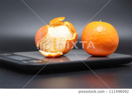 Electronic kitchen scale with two tangerines, calorie counting. Electronic kitchen scale with two tangerines, calorie counting. 111496092