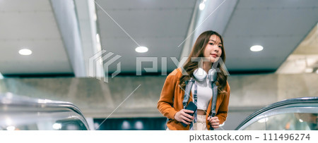 Young asian woman in international airport terminal or modern train station Young asian woman in international airport terminal or modern train station 111496274