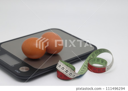Raw chicken eggs on a white background. Weight loss, weight control. Healthy food Weight control. 111496294