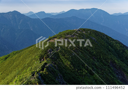 Climbers near Mt. Kosei in the Southern Alps and view of Mt. Hikari Climbers near Mt. Kosei in the Southern Alps and view of Mt. Hikari 111496452