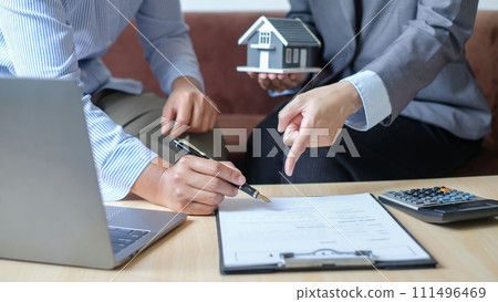 Real estate agents offer sale home insurance and close the sale immediately after the customer signs a purchase contract under a formal agreement. Real Estate Home insurance concept Real estate agents offer sale home insurance and close the sale immediately after the customer signs a purchase contract under a formal agreement. Real Estate Home insurance concept 111496469