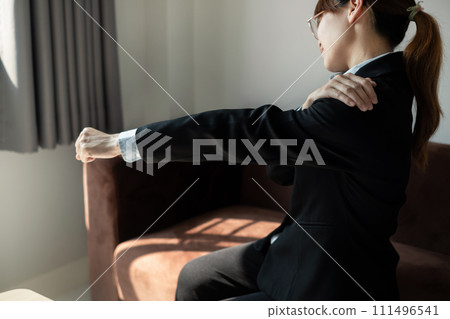 Asian female accountant is tired from working in a chair, stretching to relax and relax while working hard at the office Asian female accountant is tired from working in a chair, stretching to relax and relax while working hard at the office 111496541